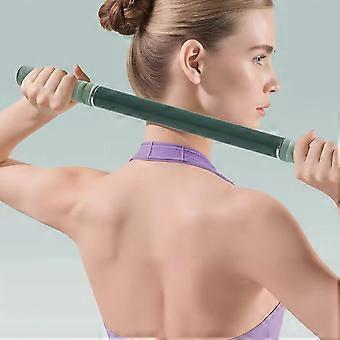 Woman holding a green bar across her back against a light gray background